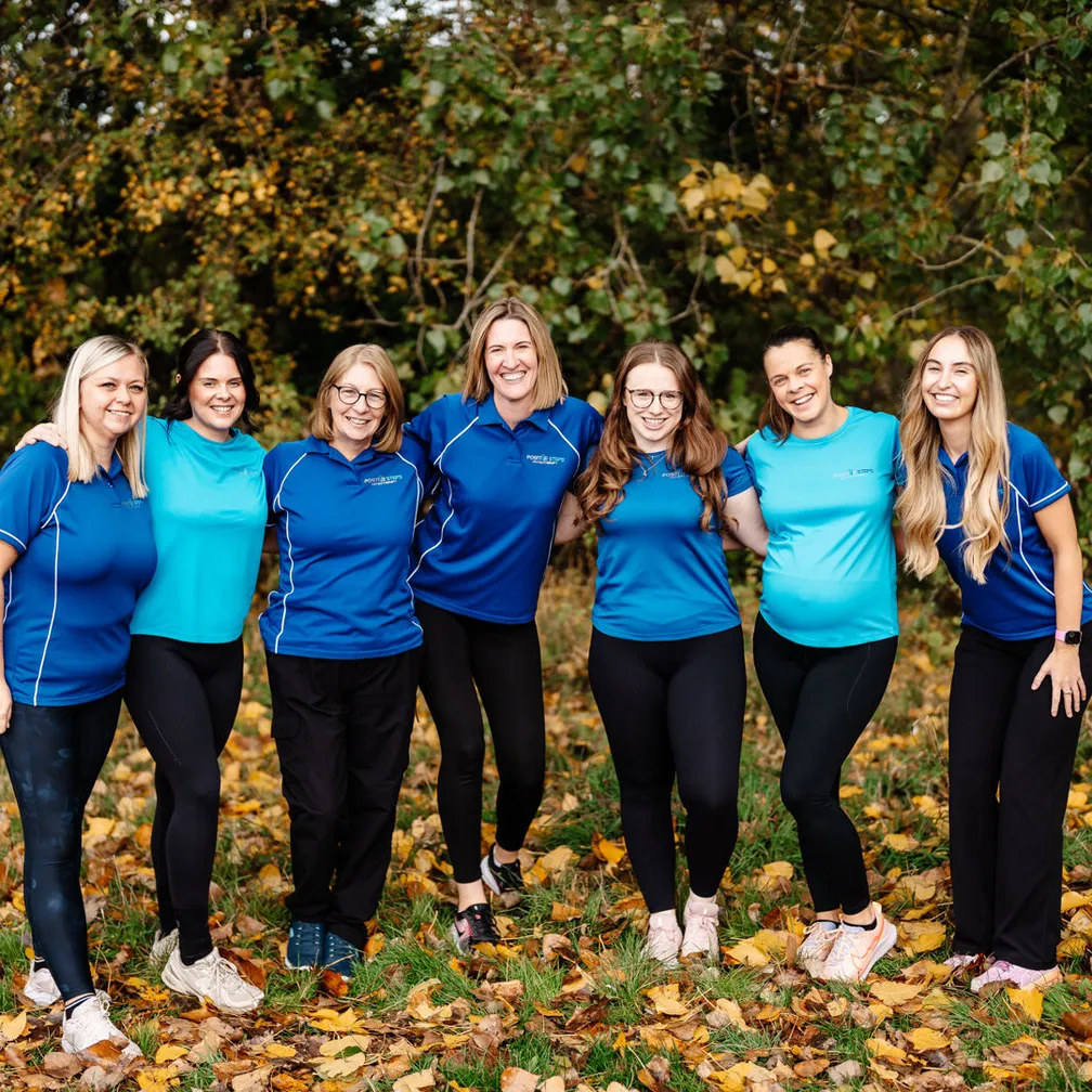 Team photo arms round each other