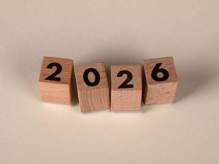 Wooden cubes forming the year 2026 on a neutral