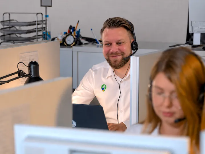 Smiling Parish Council Pigeon support team members wearing headsets at their desks