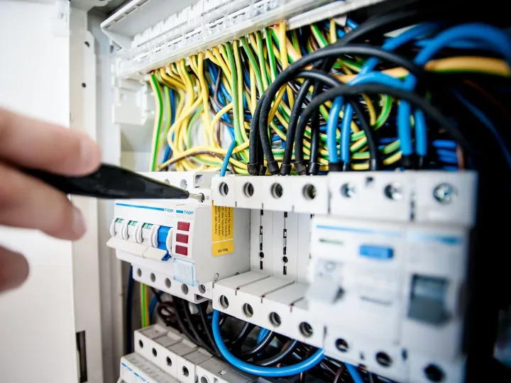 Electrician working on the wiring of a consumer unit