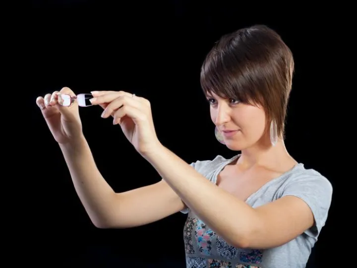 Woman inspects spectacles