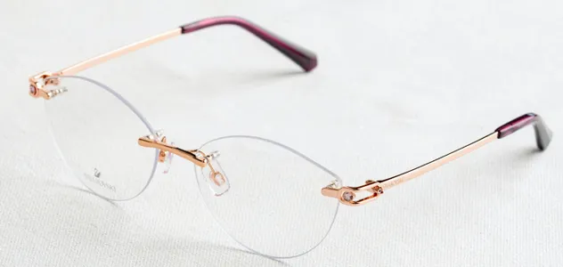 Rimless glasses on white fabric