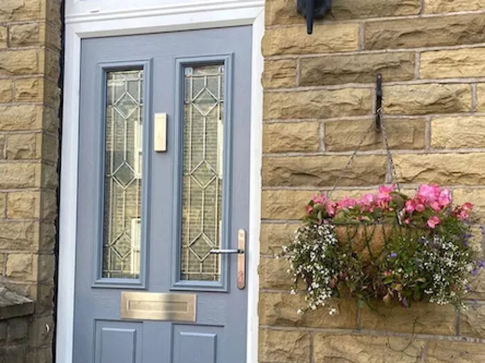 Pale grey front door with flowers