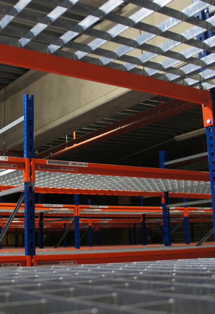 Newly painted warehouse shelving with blue columns and red beams