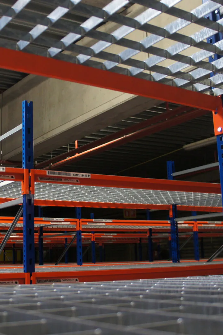 Newly painted warehouse shelving with blue columns and red beams