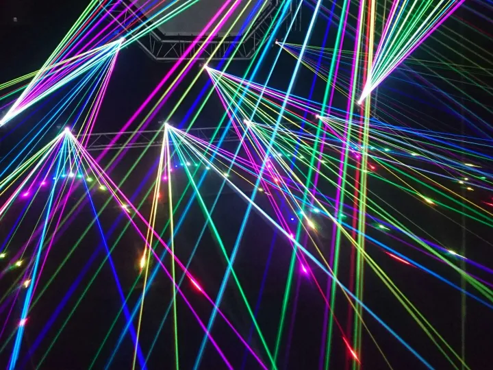 Dynamic multicolor laser beams create an electrifying display in a nighttime laser show.
