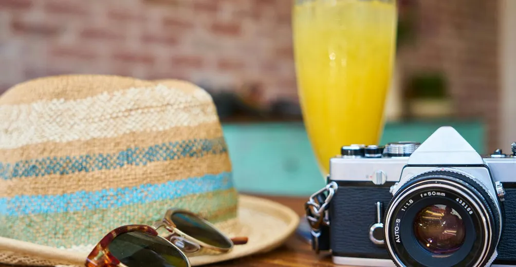 A stylish scene showcasing a vintage camera, hat