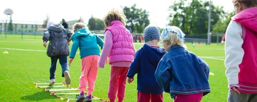 Children enjoy an outdoor activity on a grassy