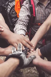 A group of diverse individuals join hands for