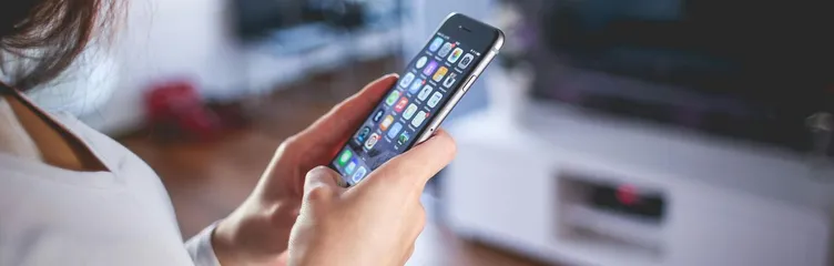 Woman browsing smartphone indoors, highlighting