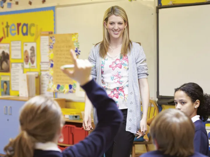 A teacher in the classroom with young children