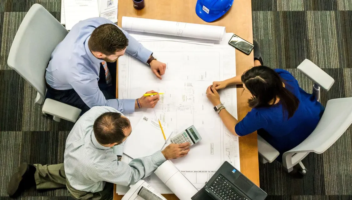 Overhead view of office desk meeting
