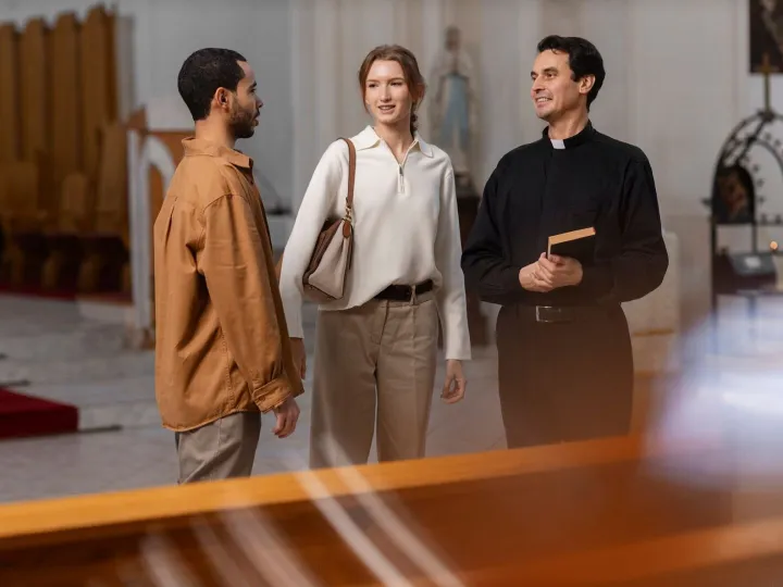 People visiting and praying in church building