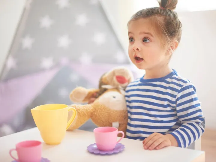 Little girl playing with her toys