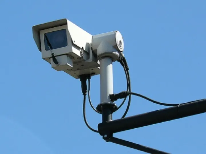 CCTV camera against blue sky