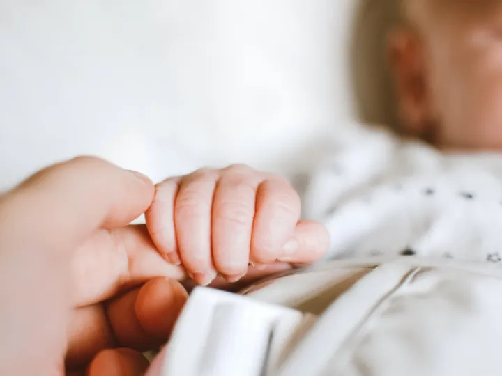 person-holding-baby-s-hand-2721581