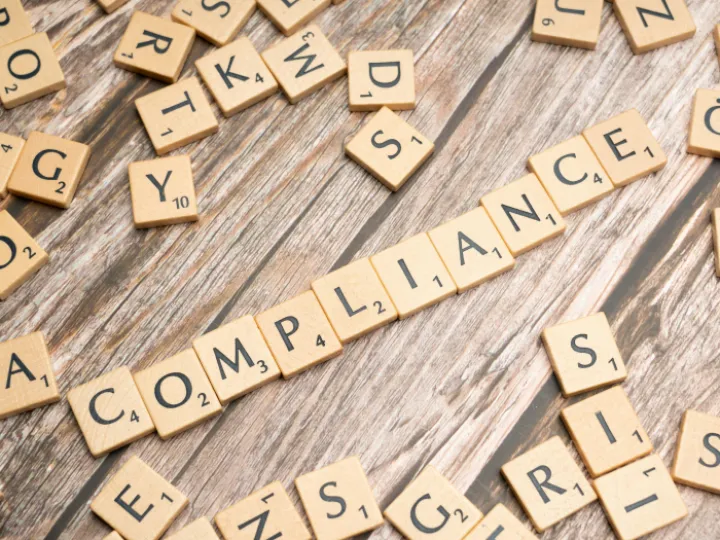 The word compliance written in scrabble letters