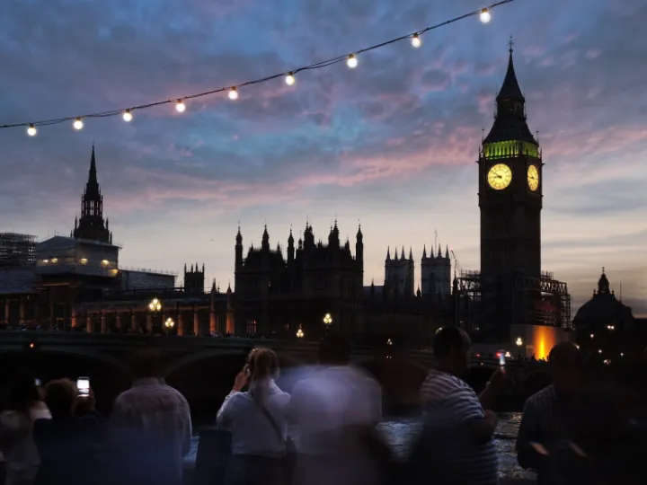 Big Ben lit up against an evening sky