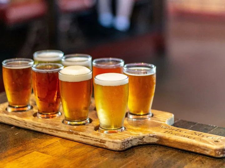 A selection of craft beers on a board at a Milwaukee pub.
