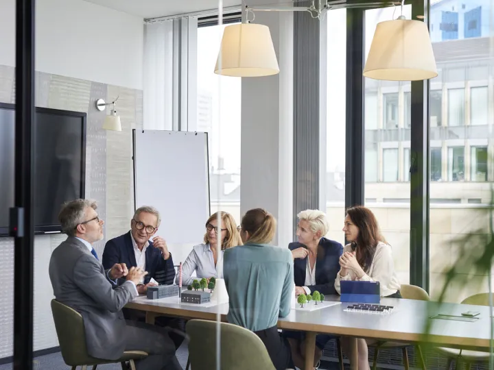 A group of people in a business meeting
