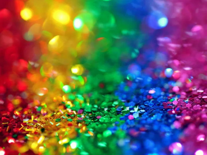 Colorful bokeh effect with vibrant rainbow glitter, perfect for festive backgrounds.