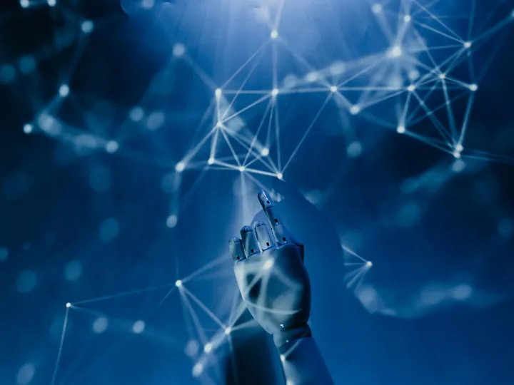 A robotic hand reaching into a digital network on