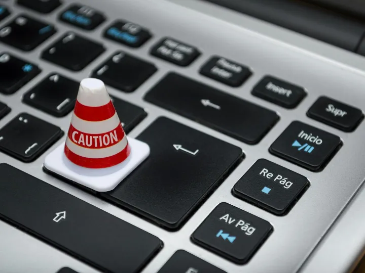 Miniature caution cone on a computer keyboard
