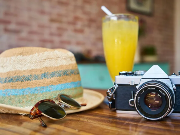 A stylish scene showcasing a vintage camera, hat