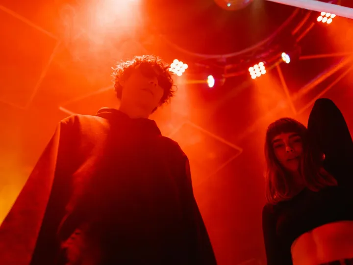 Two young adults enjoying an energetic night at a