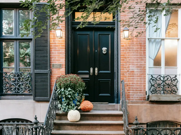 Entrance of residential building with pumpkins on