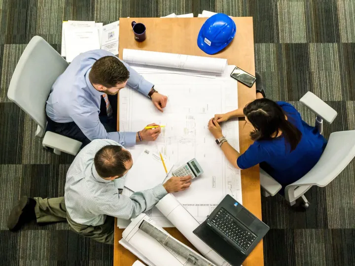Overhead view of office desk meeting