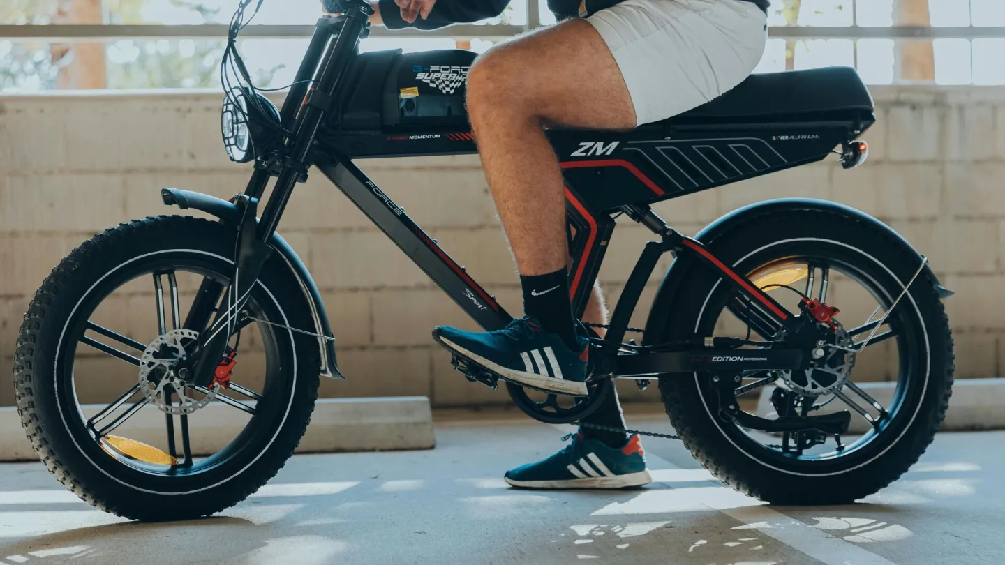 A man rides an electric bike in an urban setting