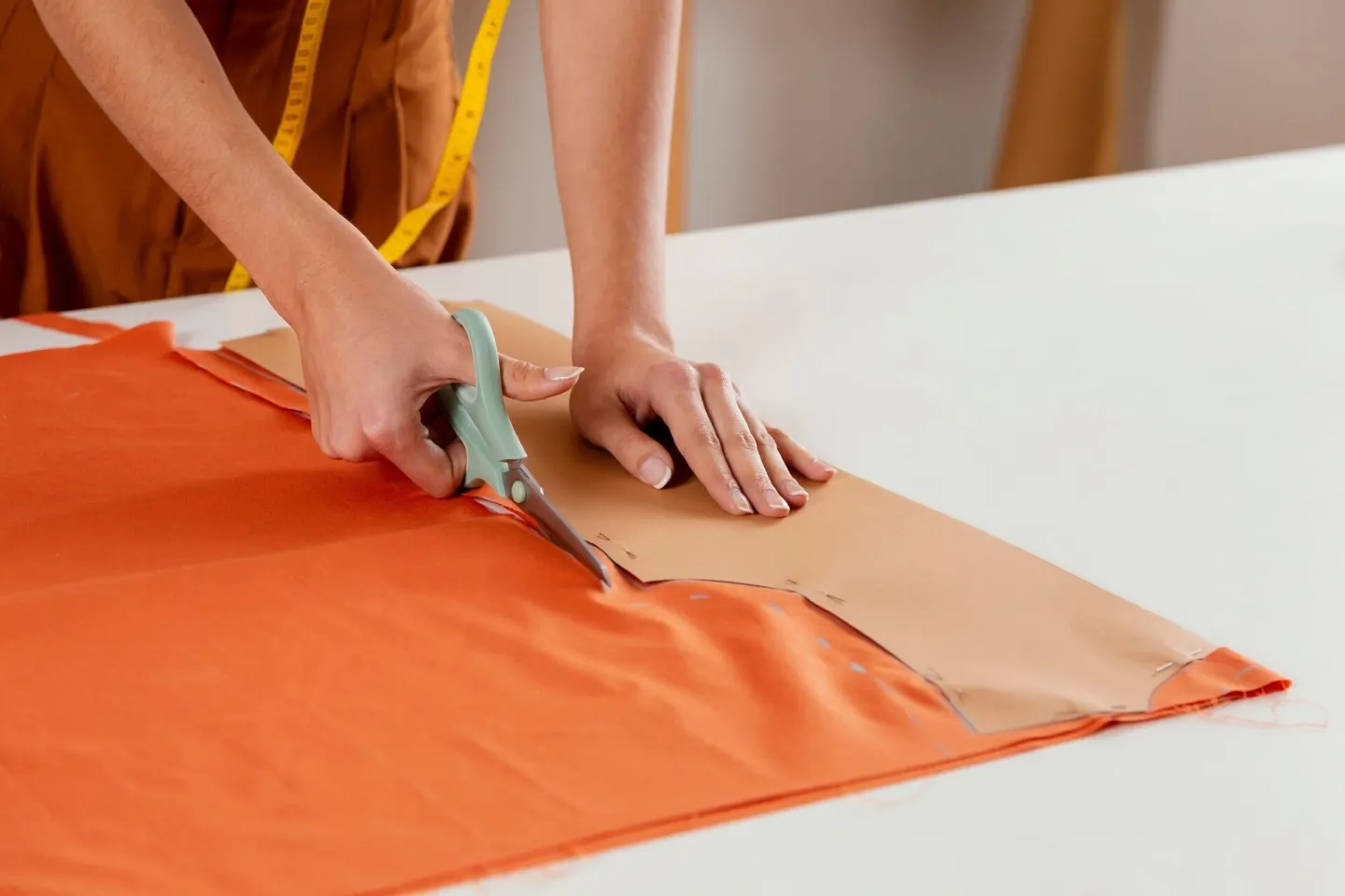 Close-up hands cutting fabric