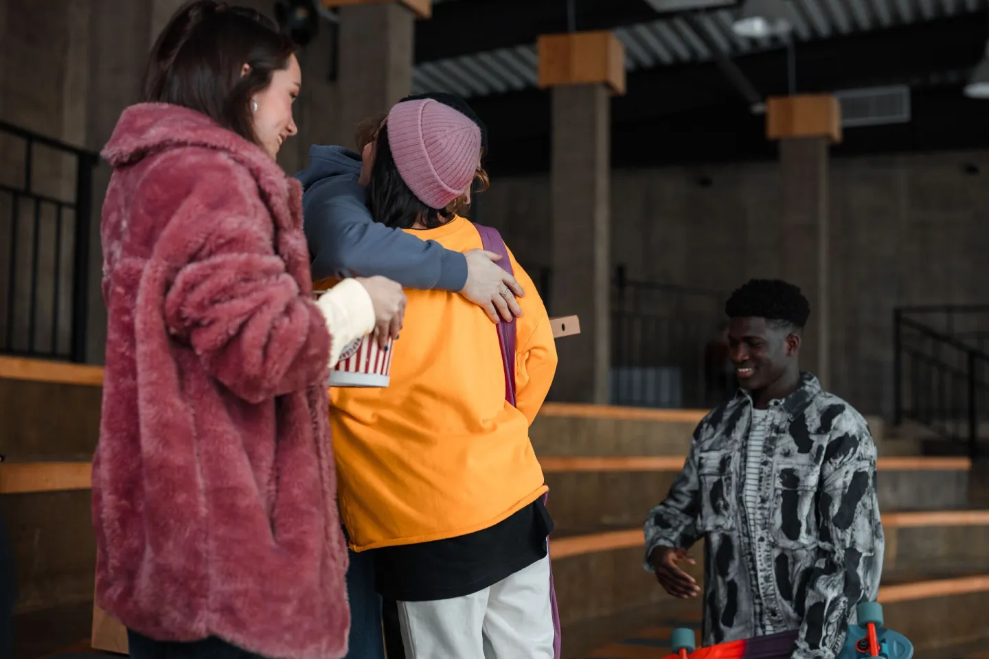 Friends greeting one another with a hug