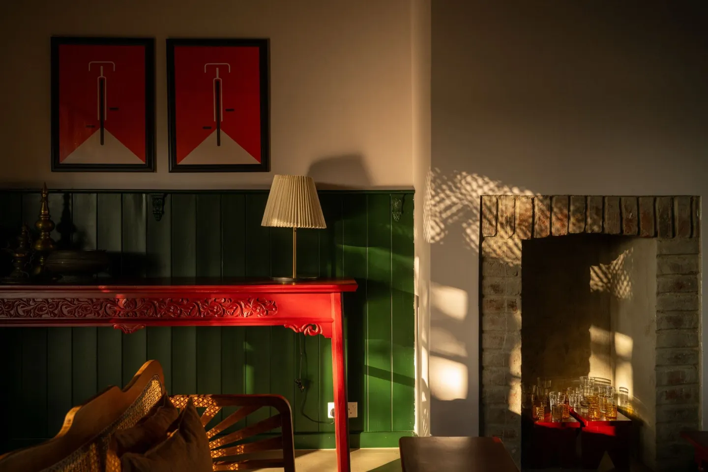 The fireplace and antique red console in the lounge at Peacock Hill Sigiriya