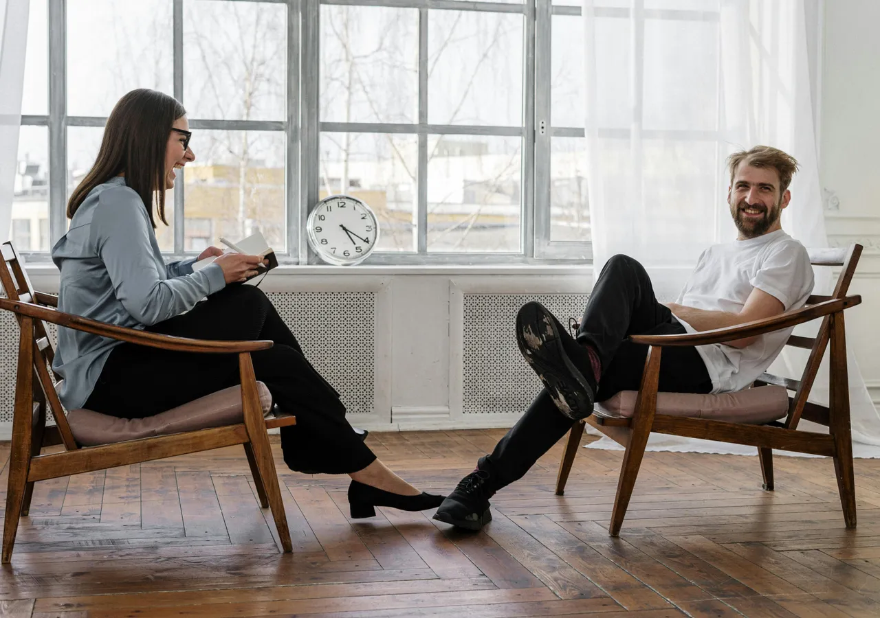 2 Women Sitting on Brown Wooden Chair