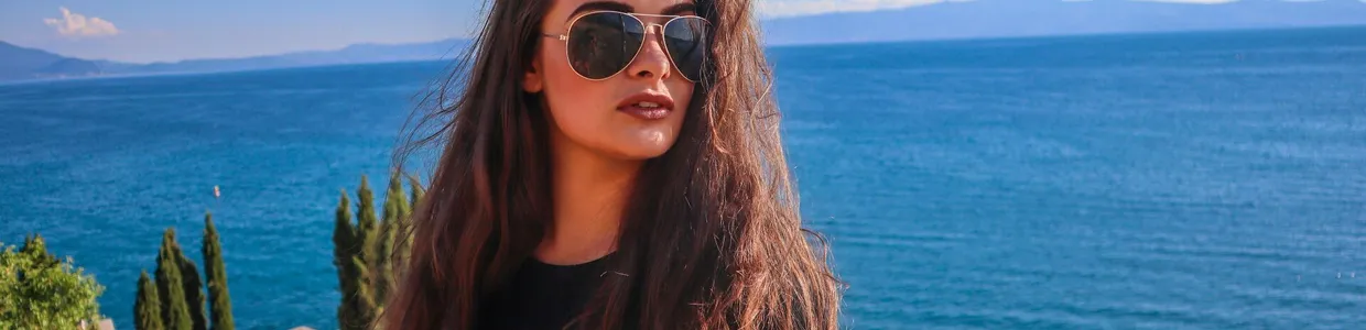 A woman with sunglasses relaxes by the serene