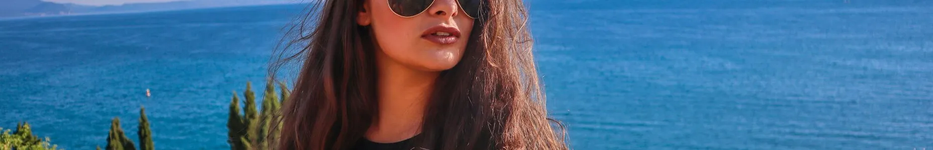 A woman with sunglasses relaxes by the serene