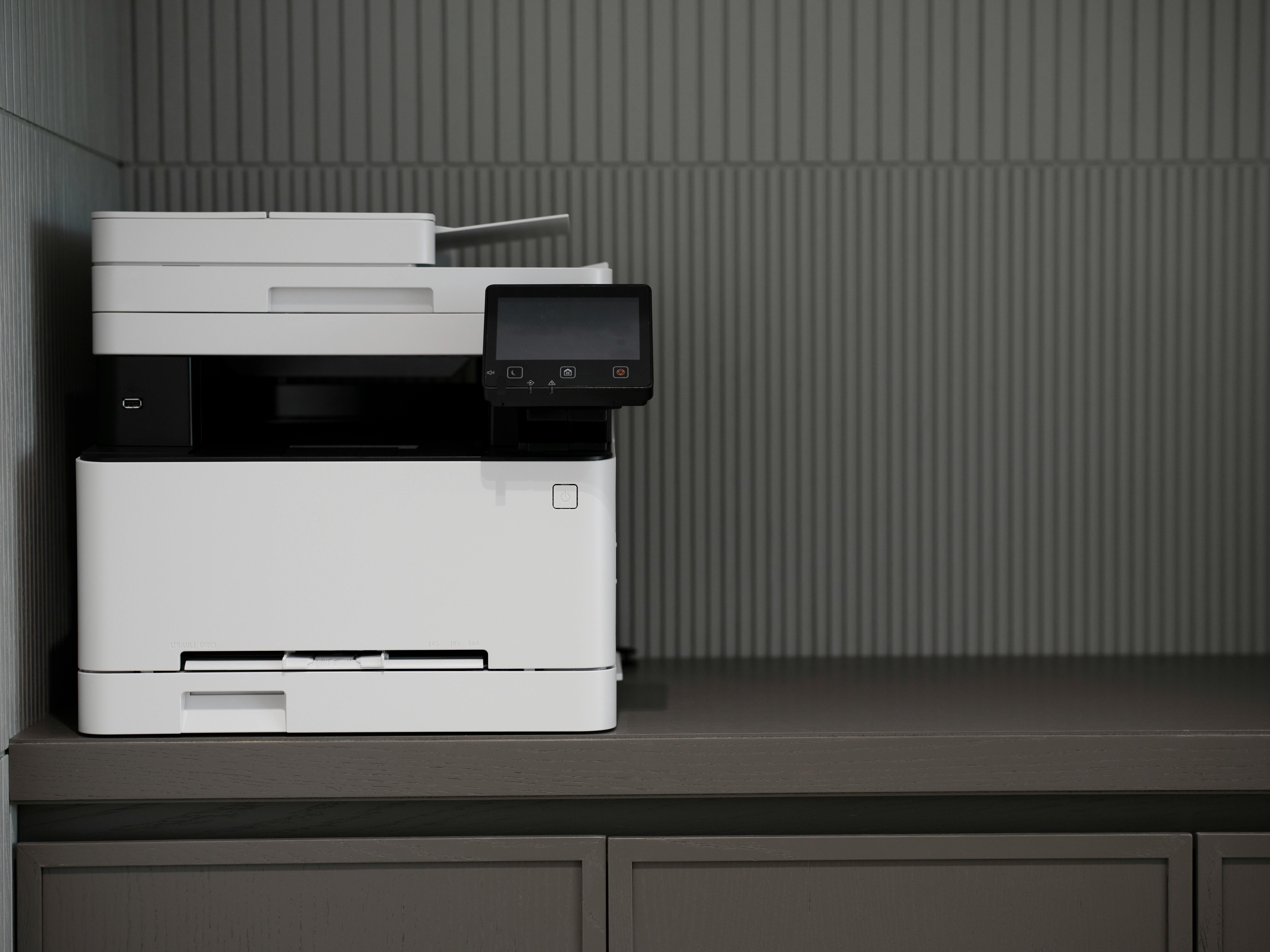 A sleek, modern printer situated on a minimalist