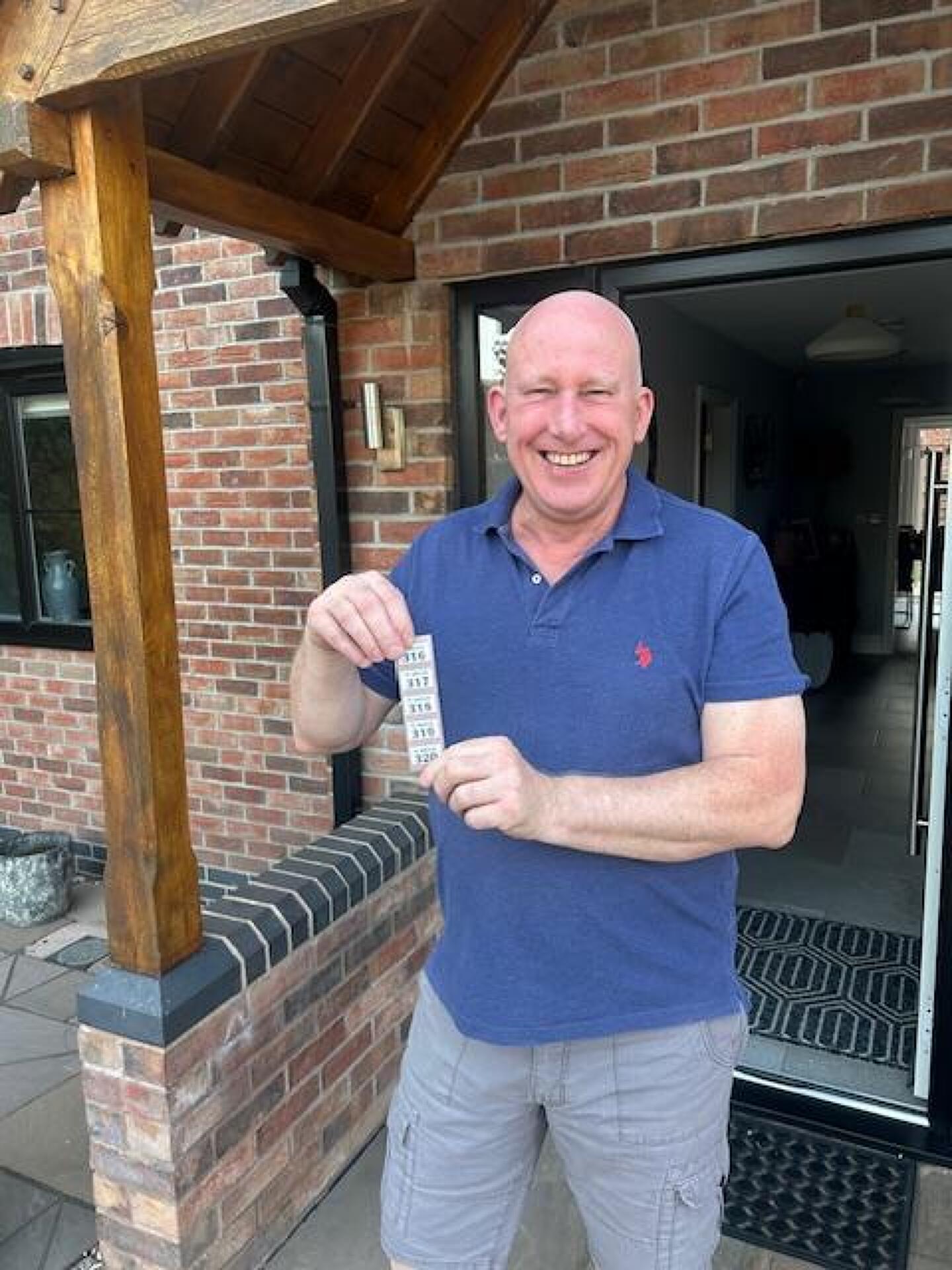 Simon Cornwall with the winning ticket