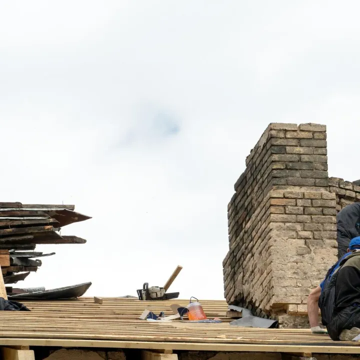 Repair of a wooden roof and an old brick chimney pipe Worker