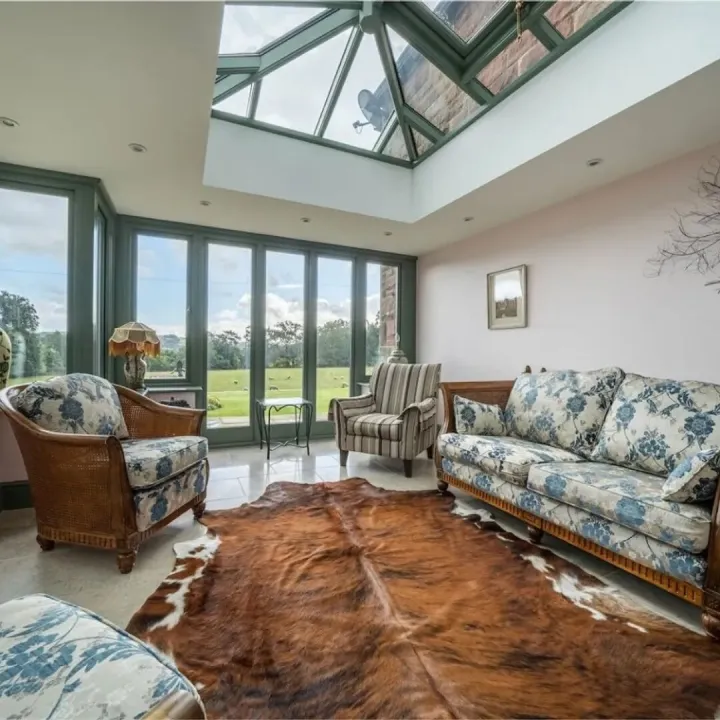 The conservatory with roof lantern and views over the gardens