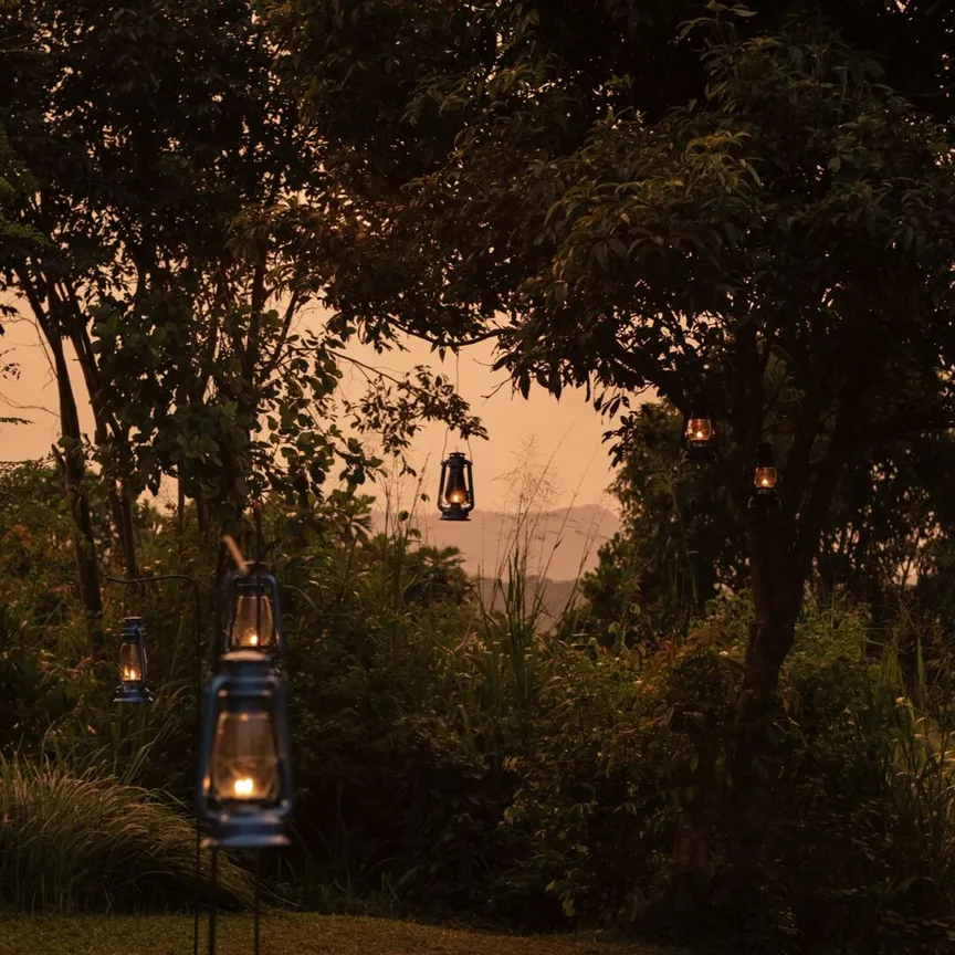 Lantern light in the tropical garden at dusk at Peacock Hill Sigiriya