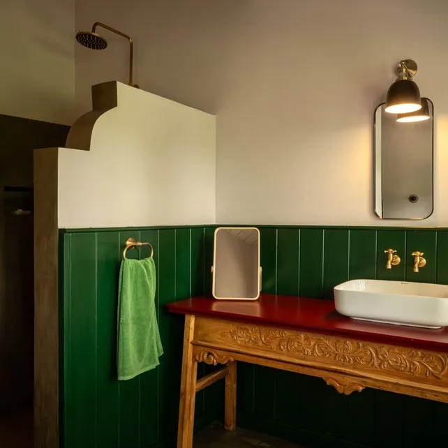 The red vanity and walk in shower in the Lake View Suite at Peacock Hill Sigiriya
