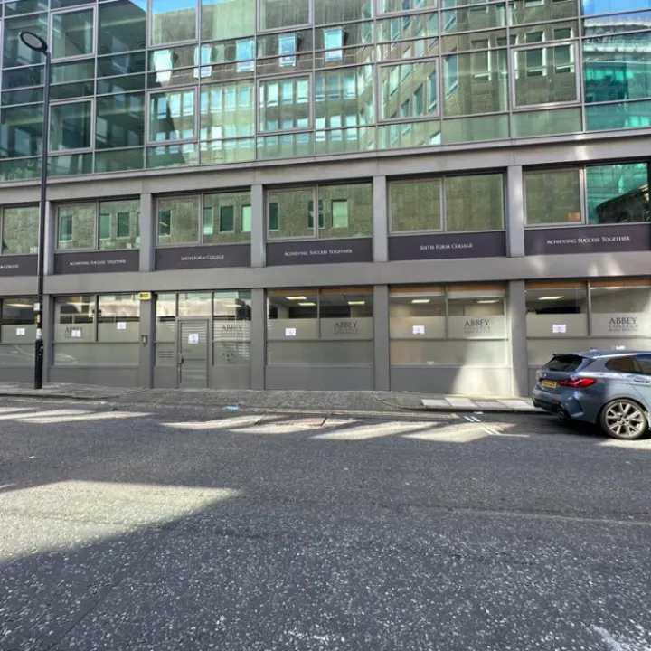 Wide view of spray painting and window panels at Abbey College Manchester.