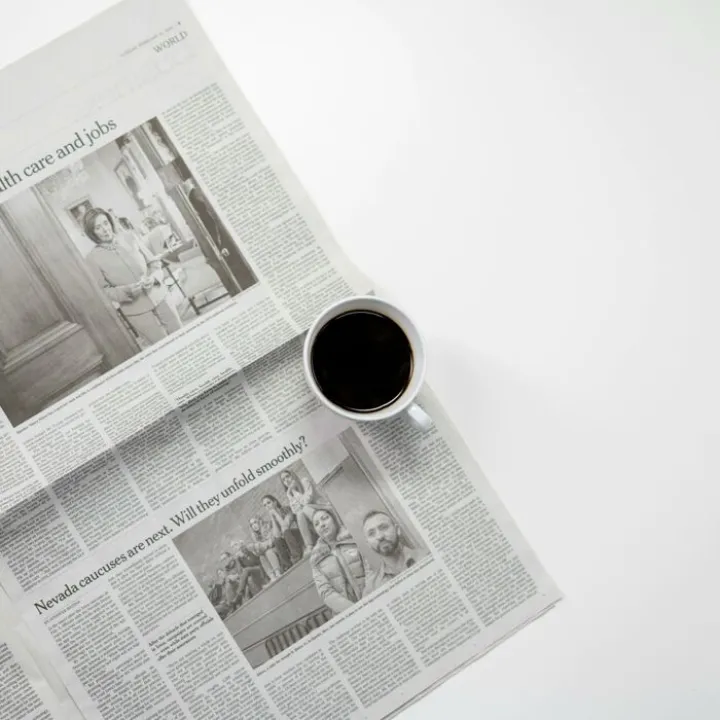 White Ceramic Mug On Top of a Newspaper