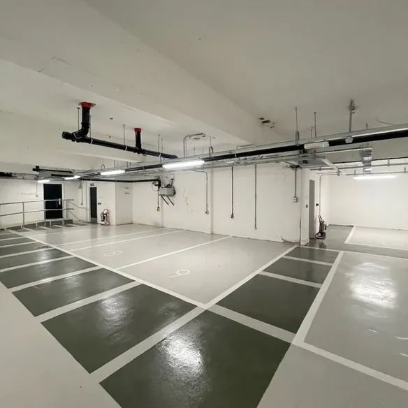 Glossy underground parking area with white markings