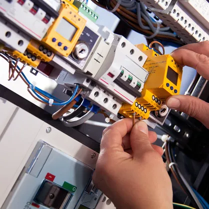 An electrician working with a fuse box