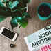 Flat lay arrangement of a coffee mug, newspaper