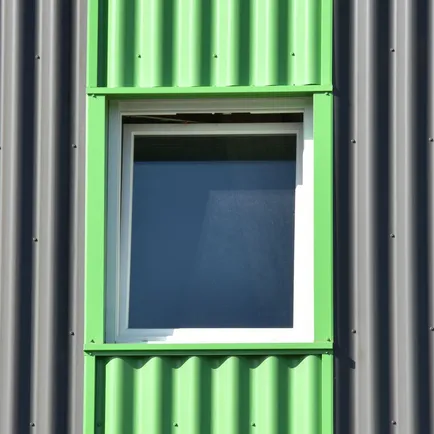 Green painted window on grey cladding